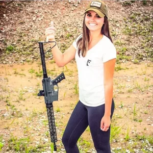 female holding a lightweight ar15 with her pinky