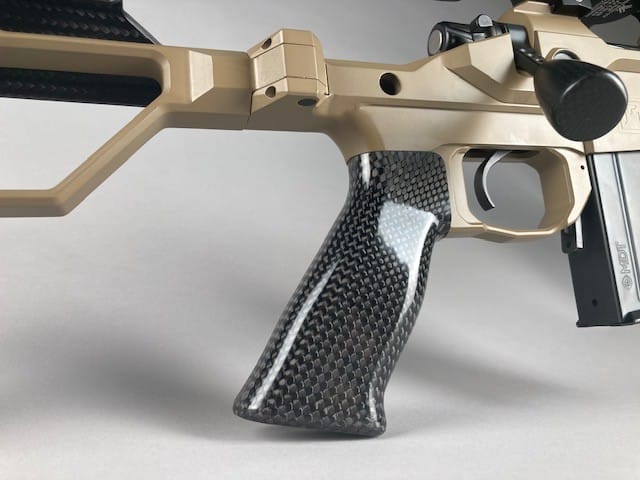 AR15 tan cerakoted rifle with carbon fiber pistol grip.