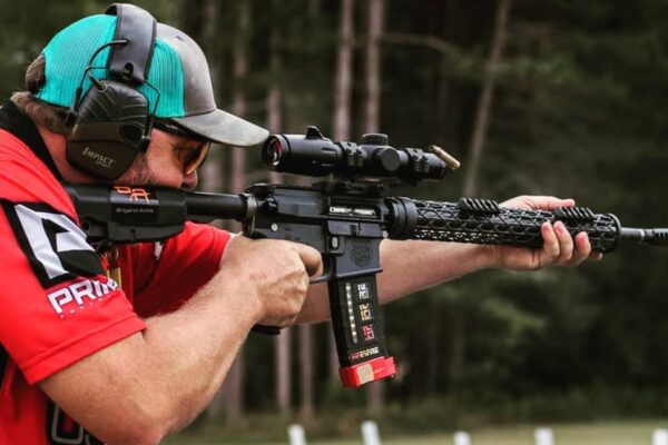 3 gun competitor aiming AR15 with carbon fiber handguard.