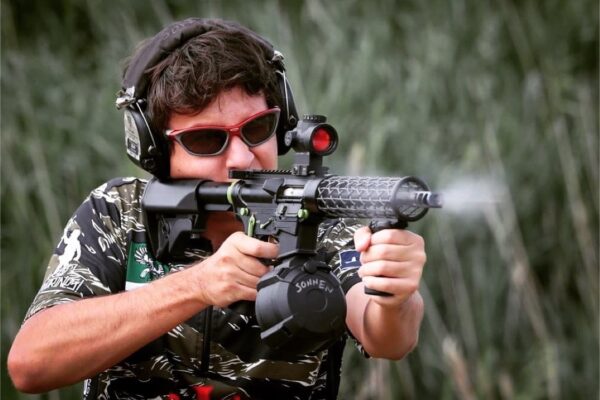 man shooting ar15 rifle wearing camo with lightweight handguard